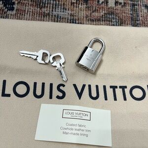 Louis Vuitton lock and key.  Never used.